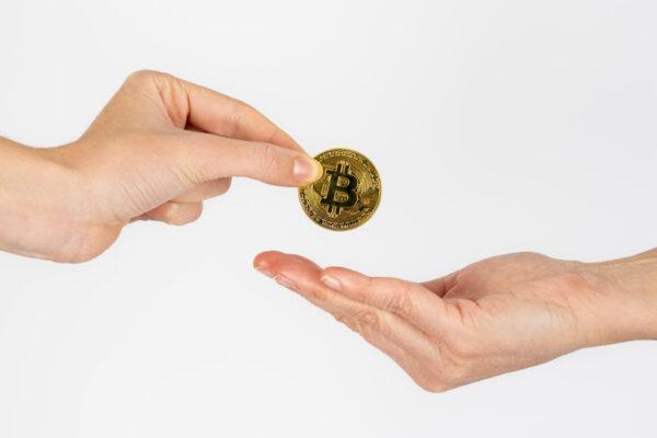 Giving Bitcoin for charity, representing secure digital currency donation and effective crypto giving methods. Supporting charitable organizations with Bitcoin.
