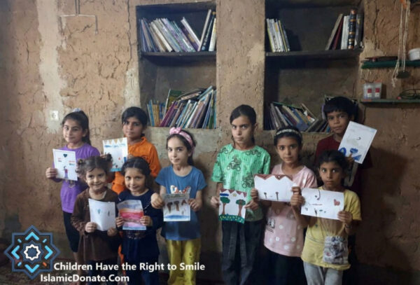 Group of children holding up drawings. The page defines Khums, a mandatory Islamic payment of one-fifth on surplus wealth to support orphans and the destitute, highlighting its scriptural basis and the benefits of donating via cryptocurrency like USDT.