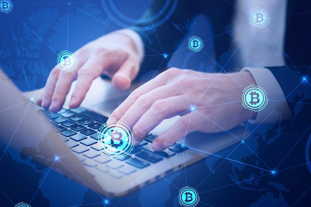 Hands typing on a laptop with a network overlay and Bitcoin symbols, illustrating secure blockchain transactions and crypto donations like BTC.