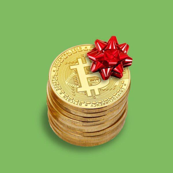 Stack of bitcoin coins with a red bow, representing crypto donations for Islamic relief efforts. Donations processed via BTC.