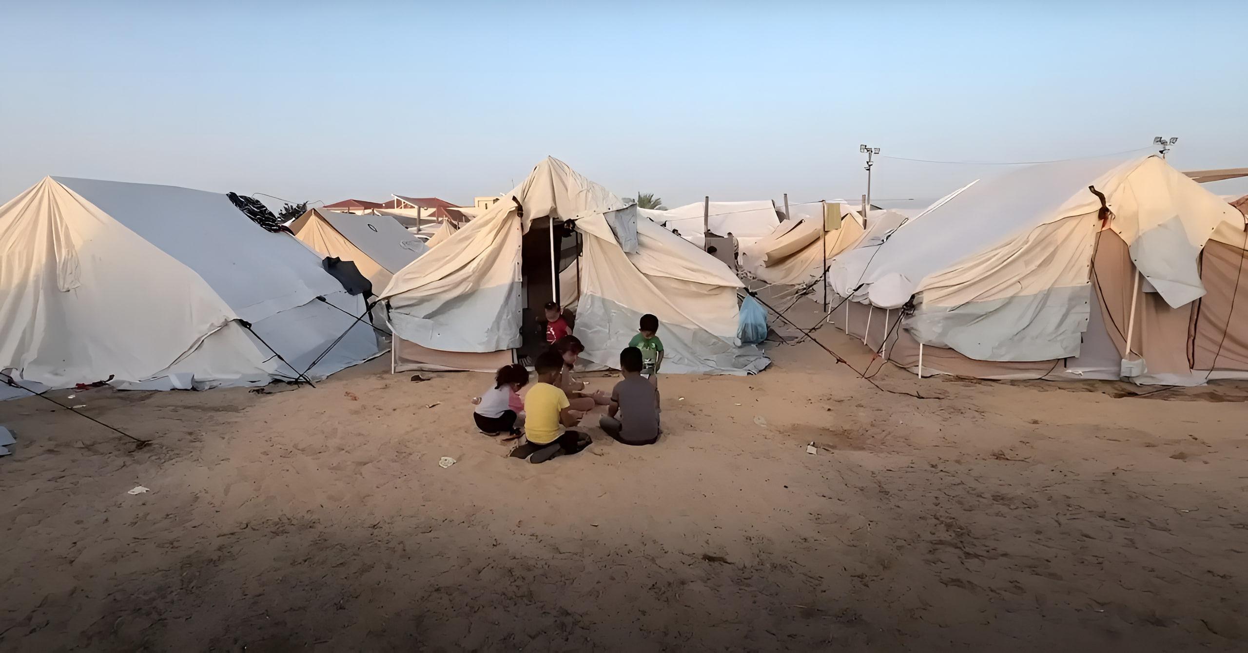 Children in a refugee camp with tents in the background, urgent need for aid. Your crypto donation, processed via Solana, provides food, water, and medical relief to displaced families in Rafah.