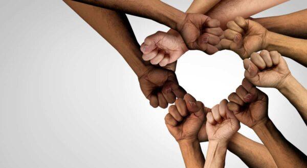 Community hands forming a heart shape, symbolizing unity and support for local Islamic charity initiatives, with donations processed via RLUSD.