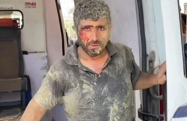 A dust-covered man with a bloody face looks out from an aid vehicle, symbolizing Yemen relief efforts and the urgent need for aid, supported by crypto via ETH.