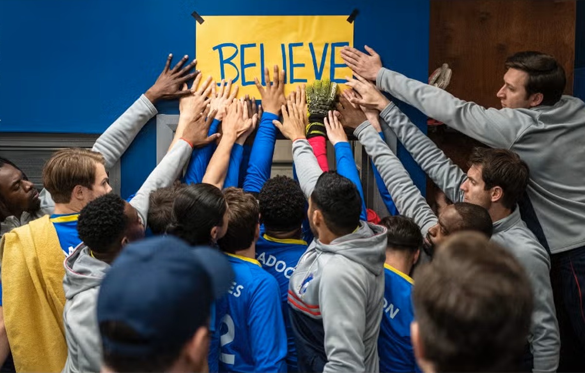 Humanitarian Solidarity football team touches BELIEVE sign for Palestine aid. Send USDC to Islamic Donate Charity.